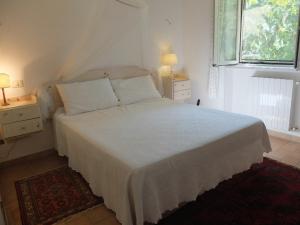 a bedroom with a white bed and a window at Bellevue, country house in Velletri
