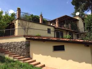 a house with stairs and a balcony on top of it at Bellevue, country house in Velletri