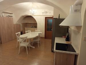 a kitchen and dining room with a table and chairs at Cassovia Hostel in Košice