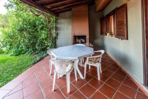 a table and two chairs on a patio at Asfodeli Holiday Home in Monte Nai