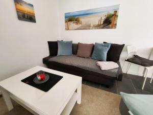 a living room with a couch and a table at Apartment Studio-Wohnung Heide2 mit Terrasse by Interhome in Walsrode
