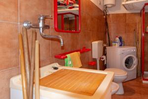 a bathroom with a sink and a washing machine at Asfodeli Holiday Home in Monte Nai