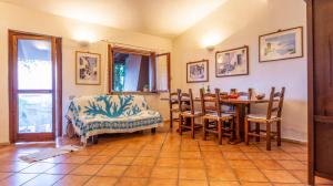a kitchen and dining room with a table and chairs at Asfodeli Holiday Home in Monte Nai +14 photos
