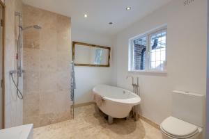 a bathroom with a tub and a shower and a toilet at Harbourways Emsworth, Pet Friendly Coastal Retreat, Contractors & Leisure, Free Parking, Walk to Pubs in Emsworth +102 photos