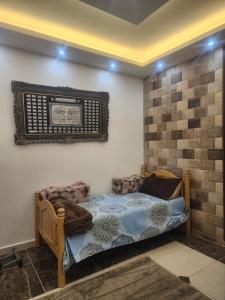 a bedroom with a bed and a mirror on the wall at A big Family nice sunset flat in Amman