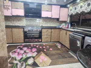 a kitchen with roses on the floor and a box at A big Family nice sunset flat in Amman +17 photos