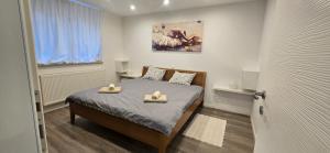 a bedroom with a bed with two towels on it at Apartman Tango in Zaprešić
