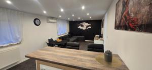 a living room with a table and a living room with a couch at Apartman Tango in Zaprešić