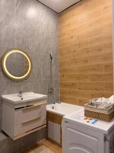 a bathroom with a sink and a toilet and a mirror at ЖК Tandau 399 in Almaty +25 photos