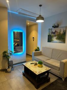 a living room with a couch and a table at Supernova spira in Noida