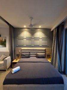 a bedroom with a large bed and a couch at Supernova spira in Noida