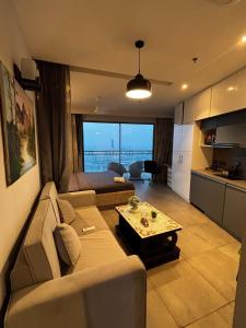 a living room with a couch and a table at Supernova spira in Noida