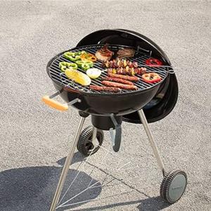 a charcoal grill with meat and vegetables on it at Villa Mediterranea in Scopello