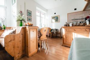 a kitchen and living room with wooden cabinets and a table at Hotel Oasi in Cortina dʼAmpezzo
