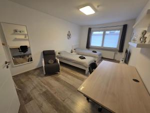 a living room with a table and a couch at Einzelzimmer für bis zu 2 Personen - 4 OG in Duisburg