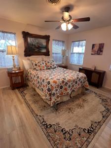 a bedroom with a bed and a ceiling fan at Wine’D Up in Fredericksburg