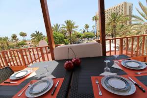 a table with plates and silverware on a balcony at BAMBÙ in Arona