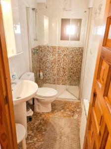 a bathroom with a shower and a toilet and a sink at El BurbyI in Somo +21 photos