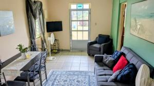 a living room with a couch and a table at Fajardo Peaceful Place in Playa Sardinera