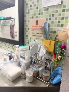a kitchen counter with a sink and alot of clutter at Happiness Hostel in Phra Ae beach +87 photos