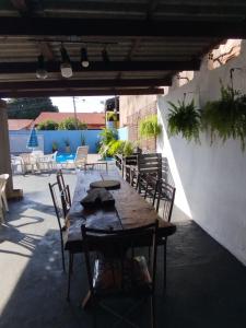 a wooden table and chairs on a patio at Casa com piscina Ana Eliza in Cambé