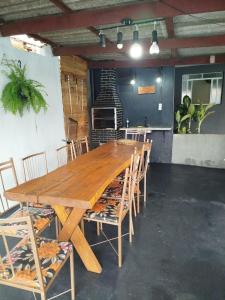 a large wooden table and chairs in a room at Casa com piscina Ana Eliza in Cambé