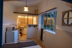 a kitchen with a white refrigerator and a microwave at Les Vergers des Maures in La Garde-Freinet