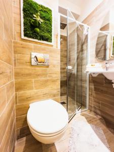 a bathroom with a toilet and a shower and a sink at Apartmán Poprad Centrum in Poprad +13 photos