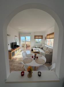 a living room with two tables and a couch at Casa Ricardo Penthouse in Sitio de Calahonda