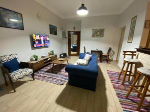 a living room with a blue couch and a table at Menna's home in Cairo +3 photos