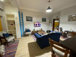 a living room with a blue couch and a table at Menna's home in Cairo