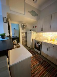 a kitchen with white cabinets and a white refrigerator at Menna's home in Cairo