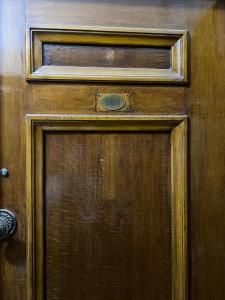 a wooden door with a clock on it at Menna's home in Cairo