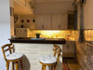 a kitchen with two chairs and a counter top at Menna's home in Cairo