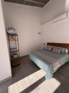 a bedroom with a large bed and a shelf at Origen Bed and Breakfast in Villargordo del Cabriel