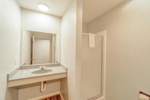 a bathroom with a sink and a mirror at HIgh Five Inn Killeen-Forthood in Killeen +28 photos