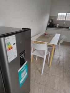 a kitchen with a table and a small refrigerator at Rincon de Olivares in Los Olivares +10 photos