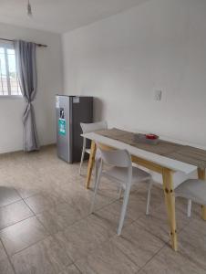 a table and chairs in a room with a refrigerator at Rincon de Olivares in Los Olivares