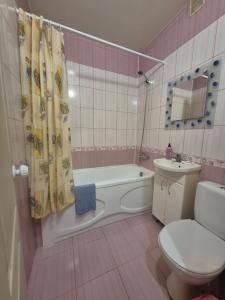 a bathroom with a tub and a toilet and a sink at Апартаменты in Izmail