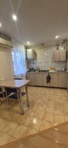 a large kitchen with a wooden table and a table sidx sidx sidx at Апартаменты in Izmail