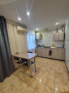 a kitchen with a table and chairs in a room at Апартаменты in Izmail