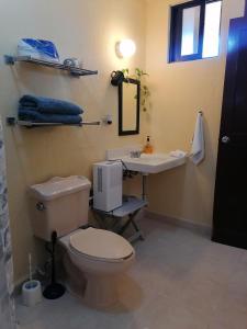 a bathroom with a toilet and a sink at Beautiful condo a few steps to sea in Cancún