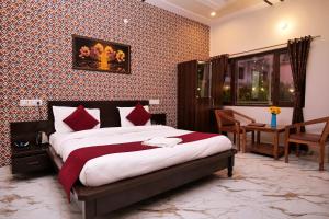 a bedroom with a bed and a desk in a room at Corbett Nature Walk - Forest View Swimming Pool Retreat in Rāmnagar