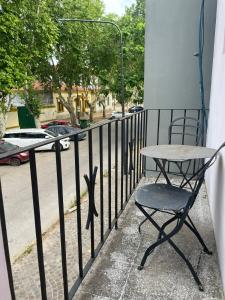 a table and a chair sitting on a balcony at EL RELOJ in Chascomús