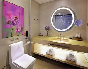 a bathroom with a sink and a mirror at Lavande Hotel Guangzhou Zhong Shan Yi Road Yang Ji Metro Stataion in Guangzhou