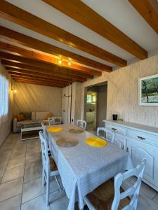 a kitchen with a table and chairs in a room at L'Ains'tant présent in Sirod
