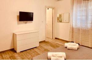 a living room with a tv and a dresser at Art home Amalfi coast in Salerno
