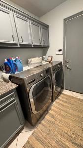 a washer and dryer in a kitchen next to a door at Andrei's nest in Oklahoma City