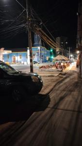 a car is driving down a street at night at Iquique Backpackers Beach House in Iquique