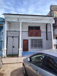 a car parked in front of a house at Iquique Backpackers Beach House in Iquique
